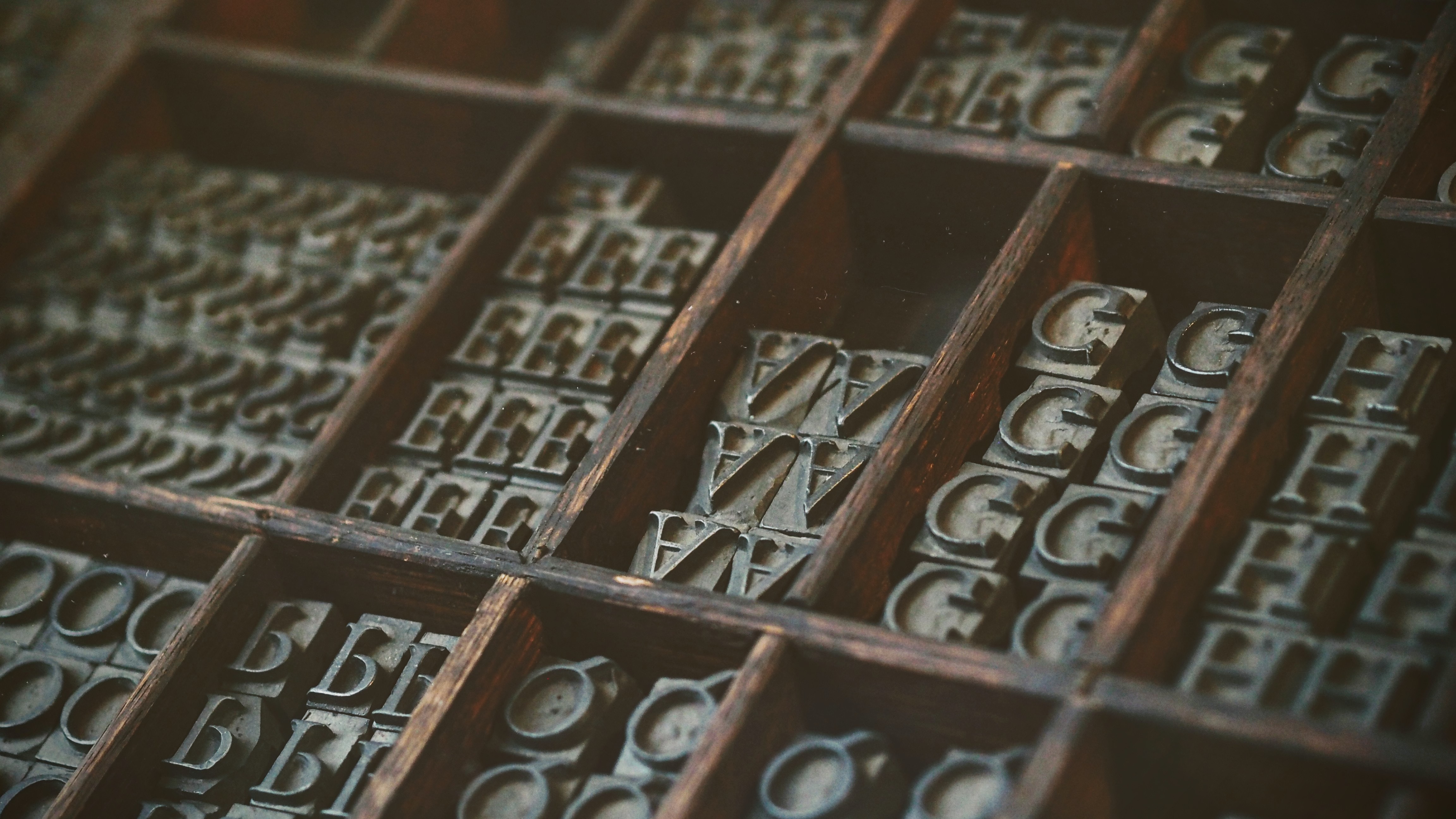 Multiple copies of movably type letters in a wooden frame